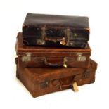 Three vintage leather suitcases