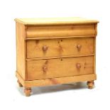 Stripped pine chest of three long drawers, 86cm wide