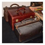 Two vintage leather Gladstone bags, together with a red leather vanity case (3)