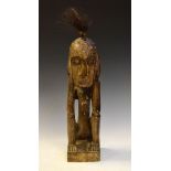 Ethnographica - African carved softwood figure of a seated native with tuft of real hair, 62cm high