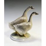 Royal Copenhagen porcelain group modelled as two grey geese on circular base, number 2068, 20.5cm