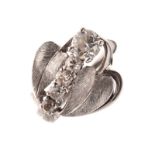 Art Nouveau-style white metal and diamond ring, set one large and four small diamond brilliants