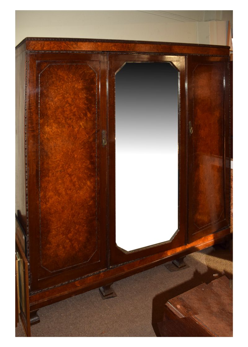 1920's period Waring & Gillows figured walnut triple wardrobe having a central mirror panel door,