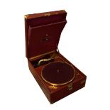 HMV salon or table top gramophone record player in red leatherette finish, together with a selection