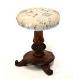 Early 19th Century rosewood circular topped music stool raised on three scroll feet