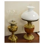 Late 19th/early 20th Century brass oil lamp having pottery reservoir and one other brass oil lamp,
