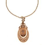 Yellow metal and seed pearl pendant of hinged two-part oval design with ribbon surmount, stamped