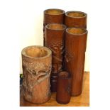 Six Oriental carved bamboo brush pots, the tallest standing 33cm high