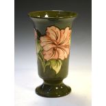 Walter Moorcroft pottery Hibiscus pattern vase of flared cylindrical form with tube lined decoration