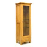 Modern oak display cabinet fitted three glass shelves and four below, 130cm high