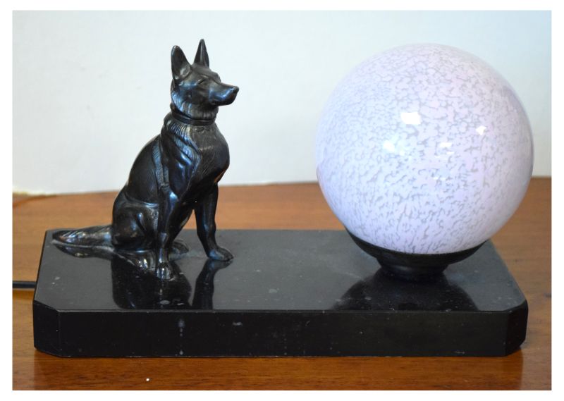 20th Century table lamp formed as a glass globe alongside a seated Alsatian dog on rectangular slate