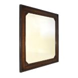 Early 20th Century oak rectangular framed mirror having canted corners to the bevelled glass,