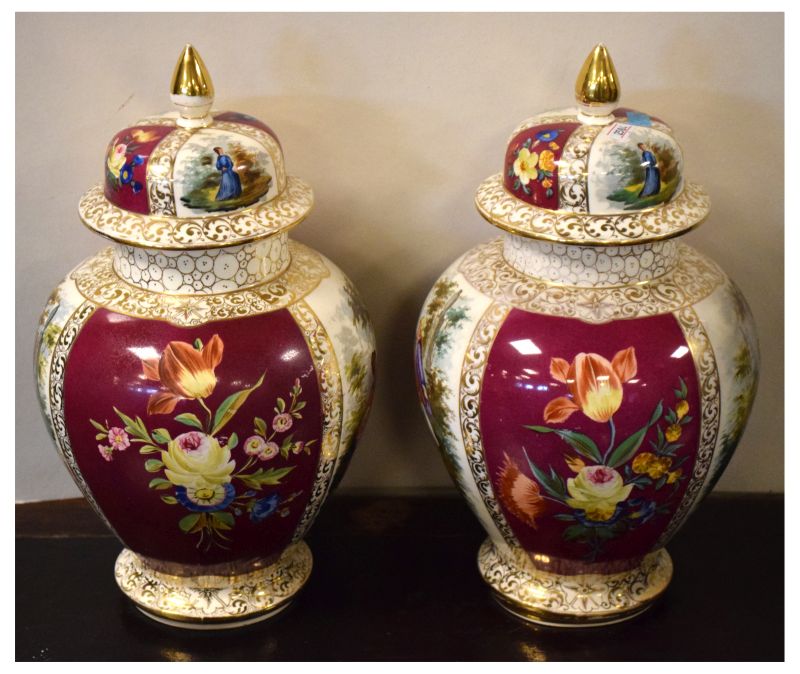 Pair of early 20th Century hand painted baluster shaped vases and covers having alternate panels