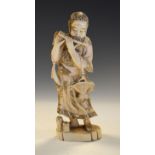 Japanese Meiji period carved ivory okimono of a bearded male musician playing a flute, three