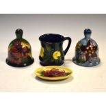 Four items of Moorcroft pottery comprising: two bells, mug and oval dish (40