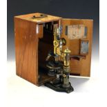 Early 20th Century lacquered brass and anodised microscope, E.Leitz Wetzlar No.117707 with rack