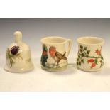 Three items of Moorcroft pottery comprising: Robin mug, Rosehip mug and Anemone bell dated 1985 (3)