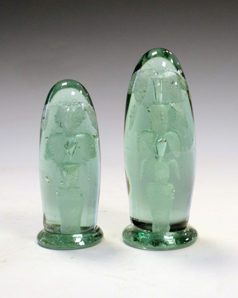 Two Victorian green glass 'dump' paperweights, each with internal bubble decoration of a potted