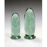 Two Victorian green glass 'dump' paperweights, each with internal bubble decoration of a potted