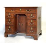 George III mahogany kneehole desk fitted one long drawer above a kneehole cupboard door flanked each