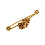Unmarked yellow metal bar brooch mounted with a gold 'nugget', 7.6g approx