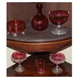 Six pieces of cranberry coloured glass