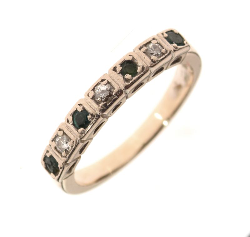 White metal, emerald and diamond seven-stone ring, set three diamonds and four alternating emeralds,