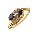 18ct gold, diamond and sapphire dress ring of crossover design set two teardrop-shaped faceted