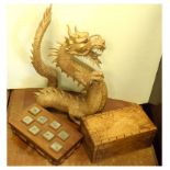 Carved figure of a dragon, 34cm high and two wooden boxes