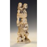 Japanese Meiji period carved ivory okimono of a bearded male figure supporting a child banging a