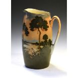 Large Royal Doulton pottery jug, decorated in shallow relief with a sunset wooded landscape,