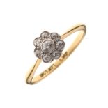 Yellow metal, platinum and diamond cluster ring, set seven stones within millegrain surround,