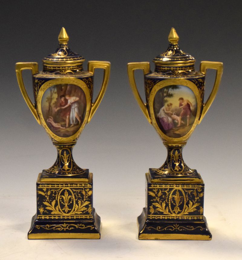 Pair of early 20th Century Austrian (Vienna) porcelain urns and pedestals, decorated with entitled