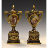 Pair of early 20th Century Austrian (Vienna) porcelain urns and pedestals, decorated with entitled