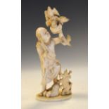 Japanese Meiji period carved ivory okimono of a falconer, the robed figure supporting four birds