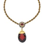 Yellow metal pendant set ruby within a border of small diamonds, with red garnet-coloured drop