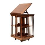Early 20th Century mahogany patent revolving bookcase, the moulded square top hinged and inclining