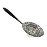 Tiffany & Co: 20th Century Sterling silver tea strainer with ebony handle, the border having