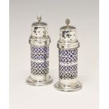 Pair of Edward VII silver lighthouse sugar casters, with allover pierced decoration and blue glass