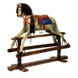 Early 20th Century painted wooden rocking horse, with studded red leather bridle and bit, padded