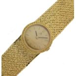 Omega - Lady's mechanical 18ct gold bracelet watch, the gold coloured round dial with gilt batons