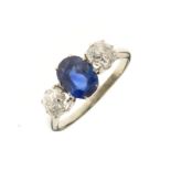 Diamond and sapphire three stone ring, the white metal unmarked, the oval cut sapphire measuring