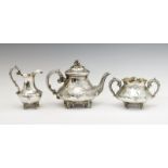 Victorian matched three piece silver tea set of bulbous form with allover floral decoration