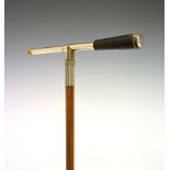 Early 20th Century Malacca novelty walking cane, the black Morocco handle concealing a two-draw