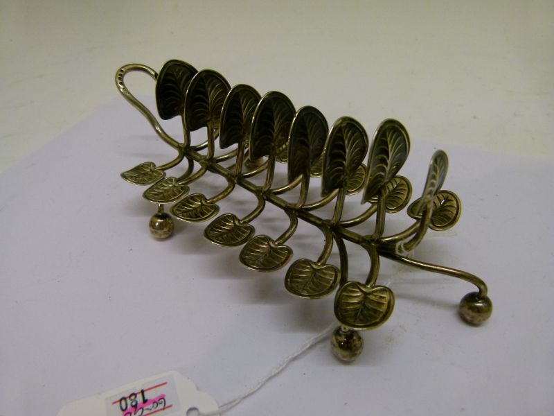 Victorian silver toast rack, having seven branches with lily pad terminals standing on four ball - Image 3 of 6