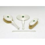 George VI silver dressing set, the brushes and mirror having decorative enamel decoration with