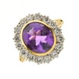 Amethyst and diamond cluster ring, with indistinct hallmark, the collet set oval cut stone measuring