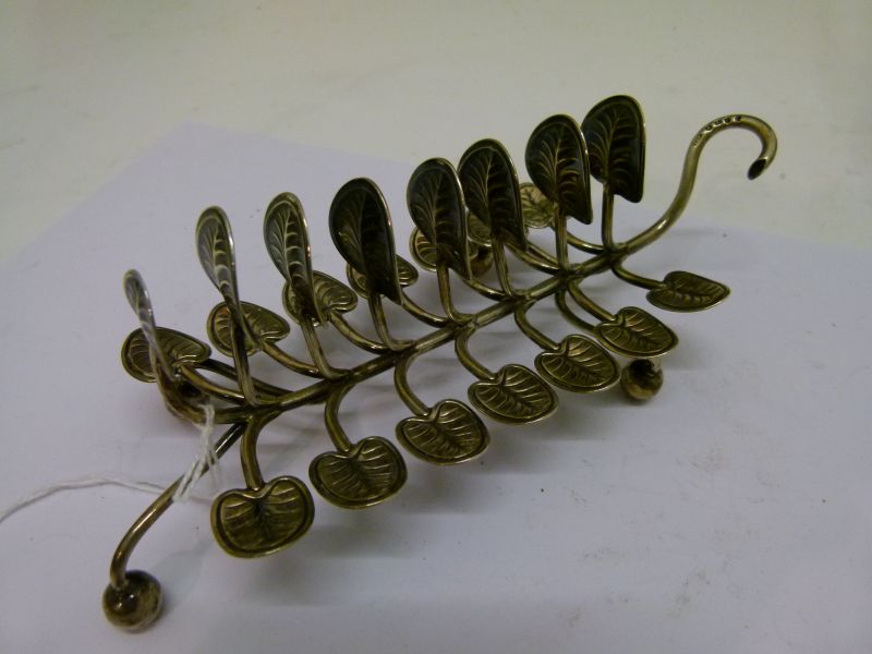 Victorian silver toast rack, having seven branches with lily pad terminals standing on four ball - Image 2 of 6