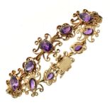 Amethyst set 9ct gold bracelet, London 1979, set with twelve oval cut stones to scroll frames, to