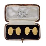 Pair of 18ct gold cufflinks, Birmingham 1923, the oval engine turned panels with chain connectors,
